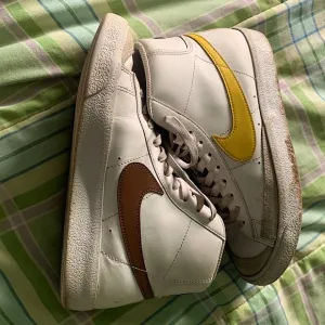 Nike blazers (yellow and brown swoosh)